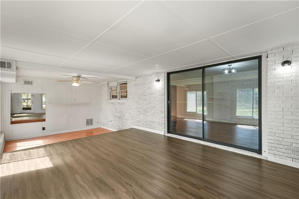 626 Grayson Parkway Grayson, GA 30017 - Photo 13 of 27 an empty room with wooden floor and windows