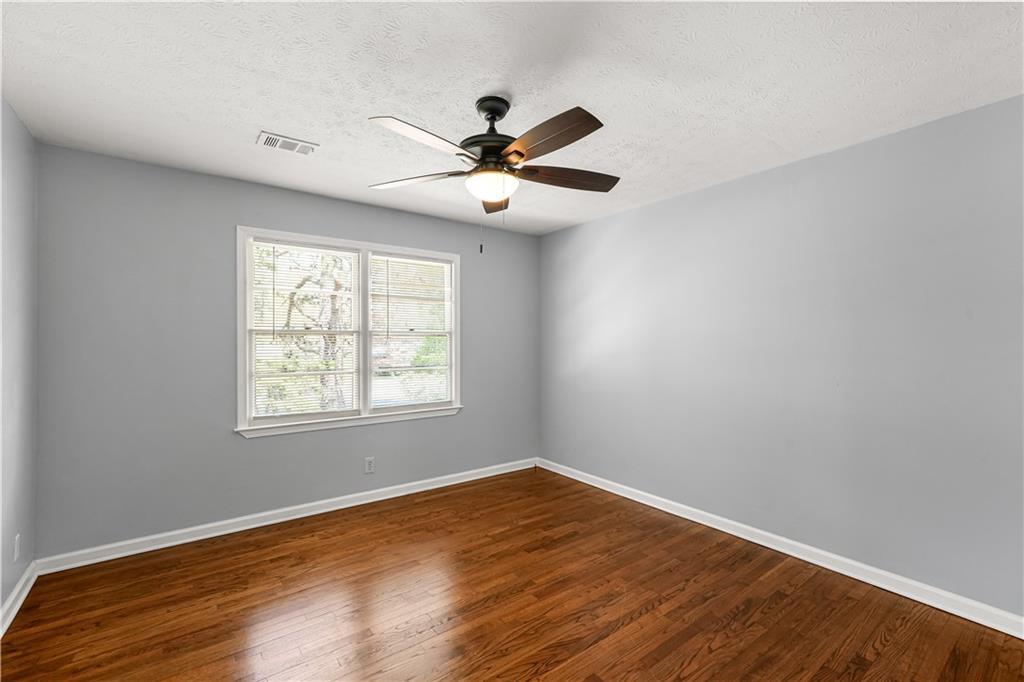 626 Grayson Parkway Grayson, GA 30017 - Photo 15 of 27 an empty room with wooden floor fan and windows