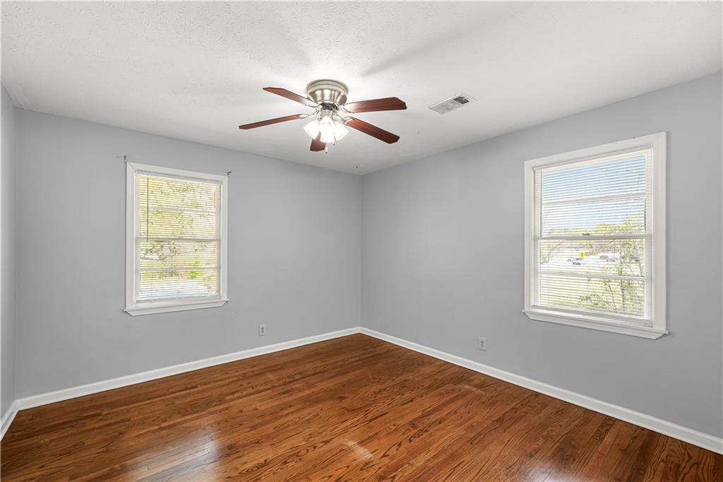 626 Grayson Parkway Grayson, GA 30017 - Photo 17 of 27 a view of an empty room with wooden floor and a window