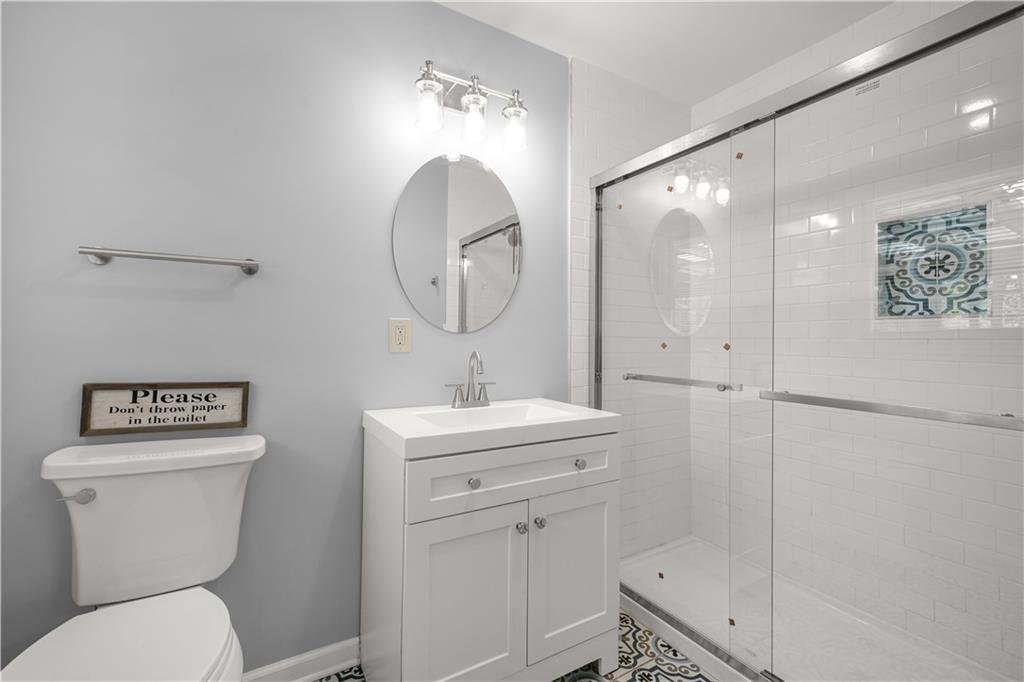 626 Grayson Parkway Grayson, GA 30017 - Photo 18 of 27 a bathroom with a toilet a sink and mirror
