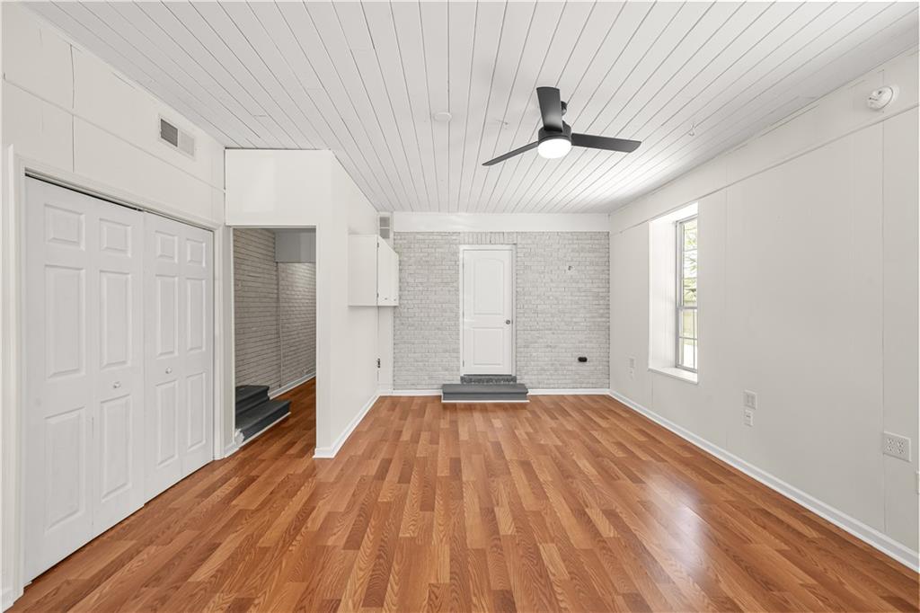 626 Grayson Parkway Grayson, GA 30017 - Photo 22 of 27 a view of empty room with wooden floor and fan