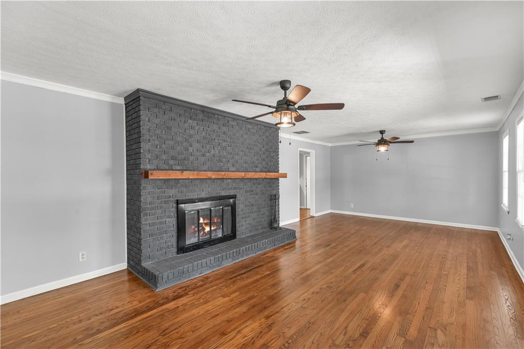 626 Grayson Parkway Grayson, GA 30017 - Photo 5 of 27 a view of an empty room with wooden floor fireplace and a window