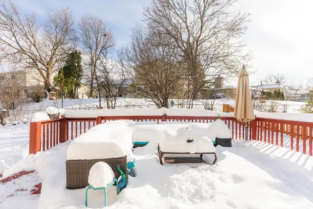 a roof deck with table and chairs