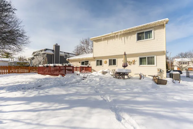a view of a house with cars parked