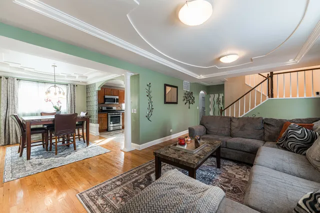 a living room with furniture a dining table and a piano