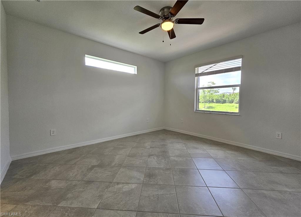 2168 Dragonfruit Way Naples, FL 34120 - Photo 11 of 27 an empty room with windows and fan view