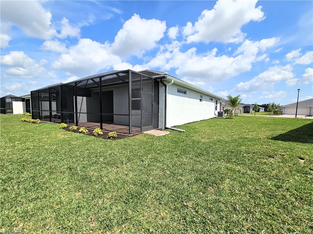 2168 Dragonfruit Way Naples, FL 34120 - Photo 22 of 27 a front view of house with yard and entertaining space