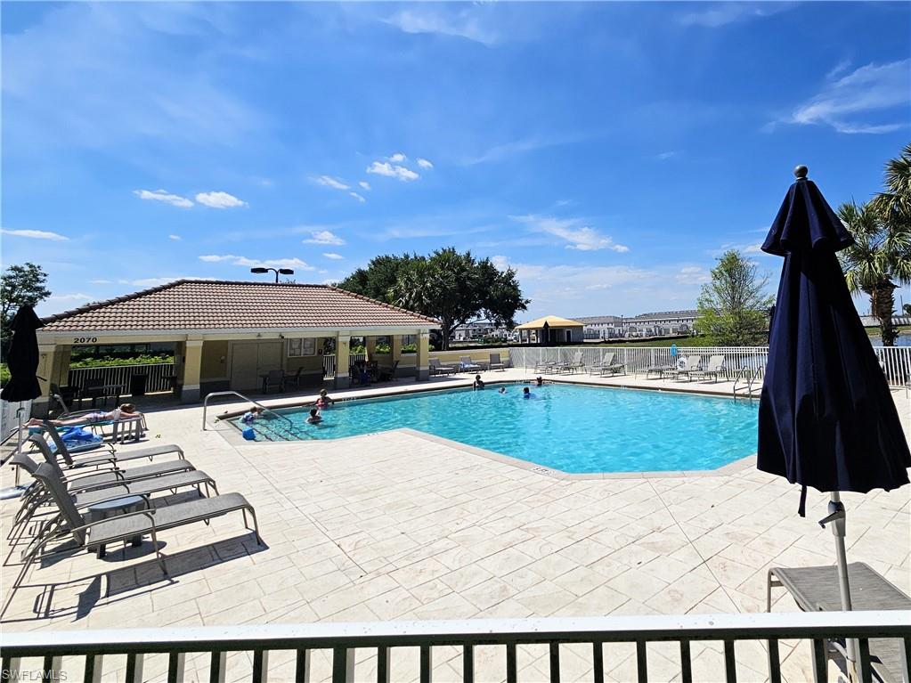2168 Dragonfruit Way Naples, FL 34120 - Photo 26 of 27 a view of swimming pool with outdoor seating