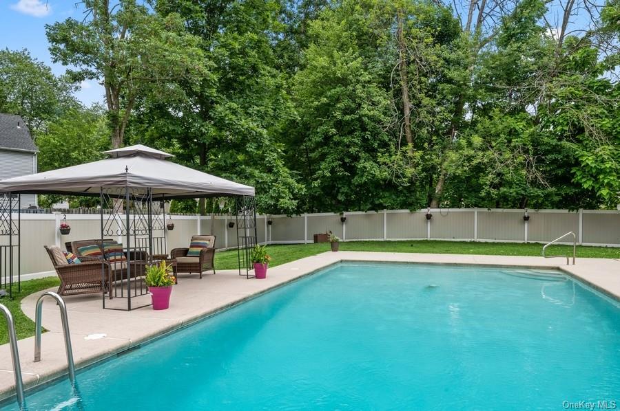21 Freund Drive Nanuet, NY 10954 - Photo 1 of 36 a view of pool with table and chairs under an umbrella