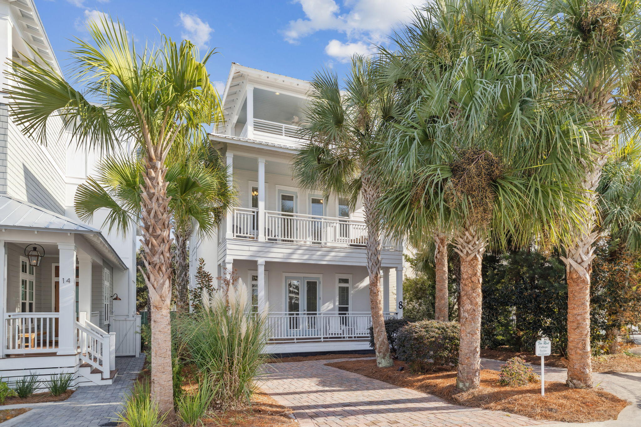 a front view of a house with a tree
