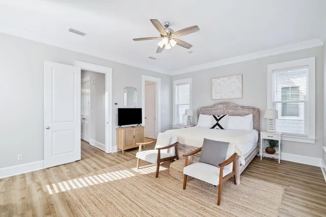 a bedroom with a bed and a flat tv screen on dresser