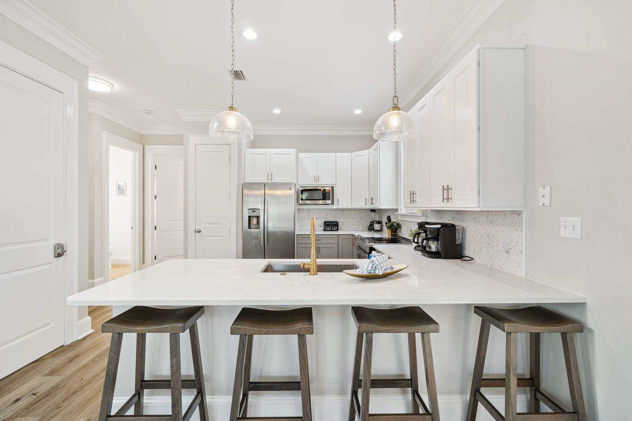 8 Barefoot Lane Seacrest, FL 32461 - Photo 3 of 62 a kitchen with kitchen island a dining table chairs sink and cabinets