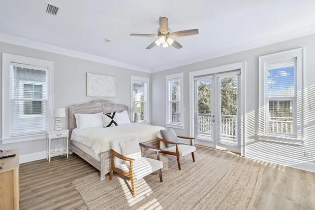 a view of a bedroom with wooden floor