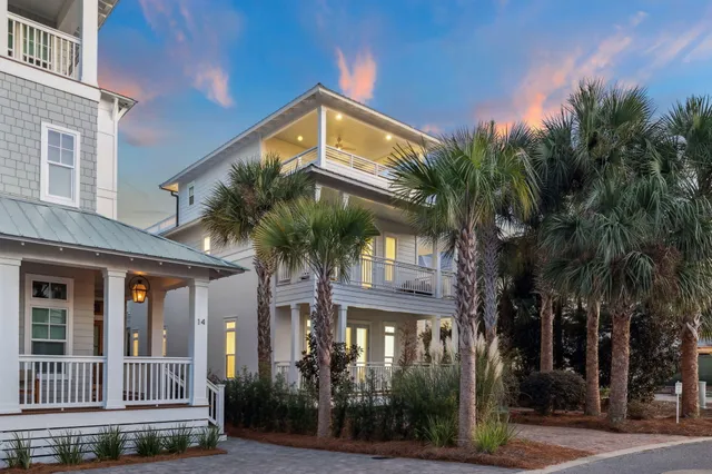 a kitchen with stainless steel appliances granite countertop a sink a stove a refrigerator and island with wooden floor