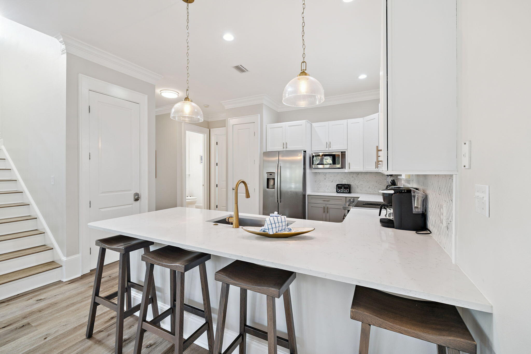 8 Barefoot Lane Seacrest, FL 32461 - Photo 9 of 62 a kitchen with a dining table chairs and white cabinets