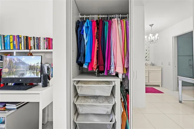 a view of a closet with storage and utility room