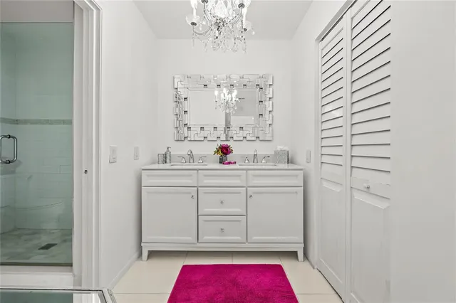 a bathroom with a tub sink vanity and mirror