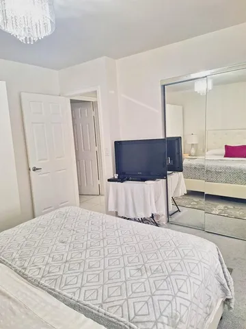 a bedroom with a large bed and a couch