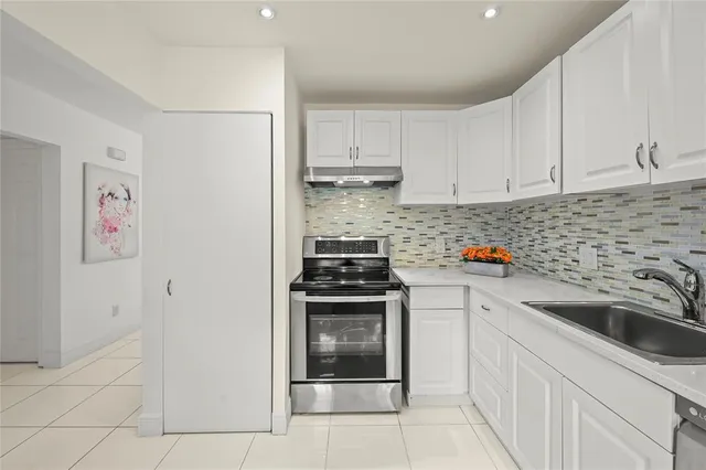 a kitchen with cabinets appliances and a sink