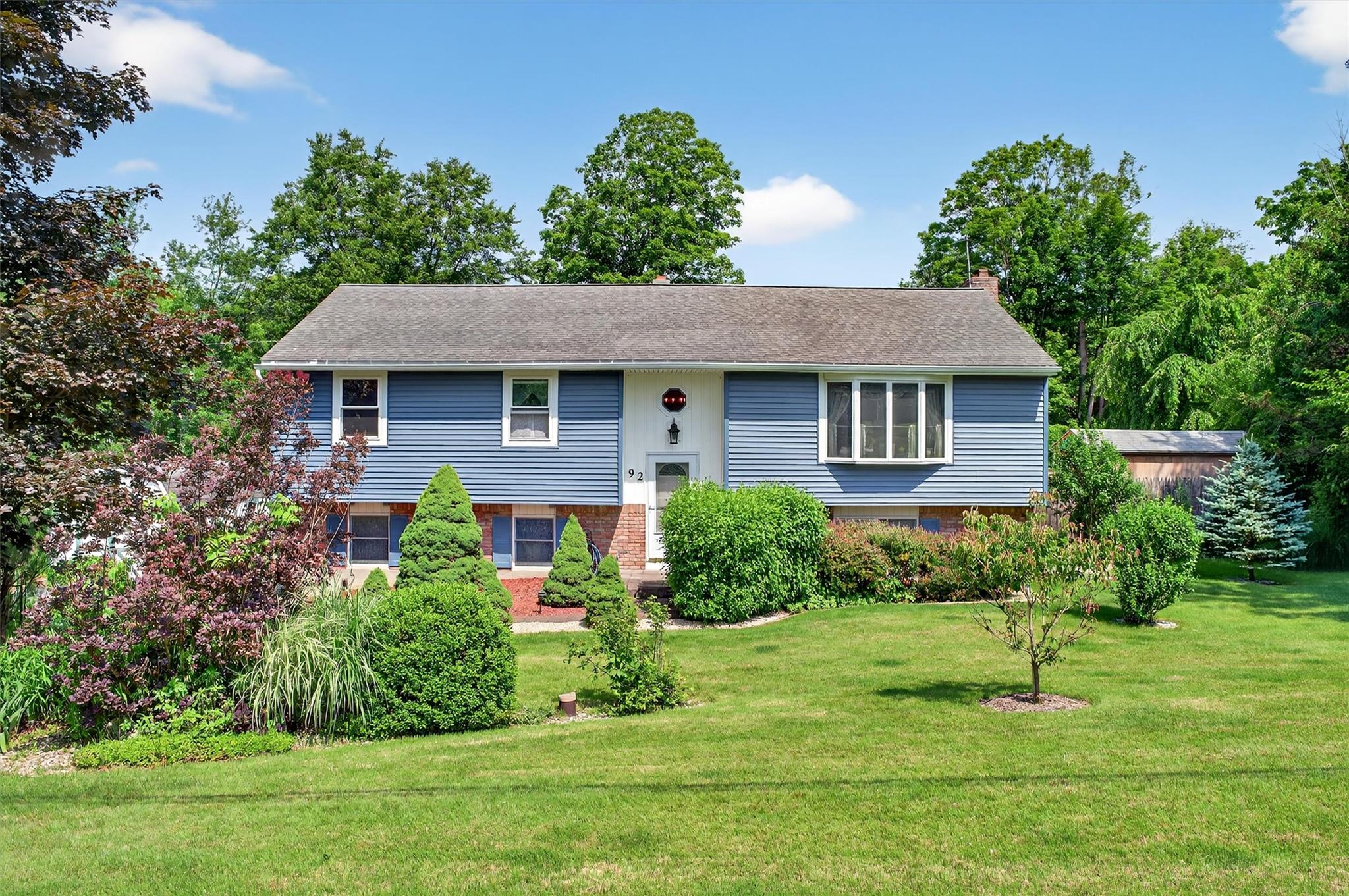 92 Gregory Road Johnson, NY 10933 - Photo 1 of 1 Bi-level home with a chimney, a front lawn, brick siding, and roof with shingles