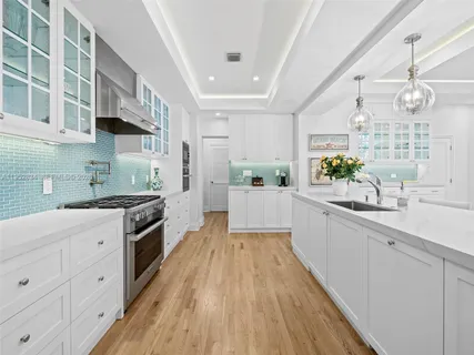 a living room with furniture and large windows