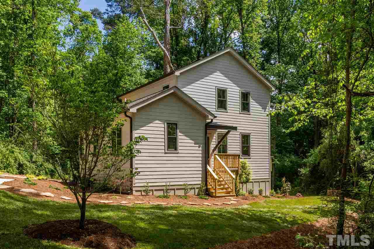 a view of house with backyard