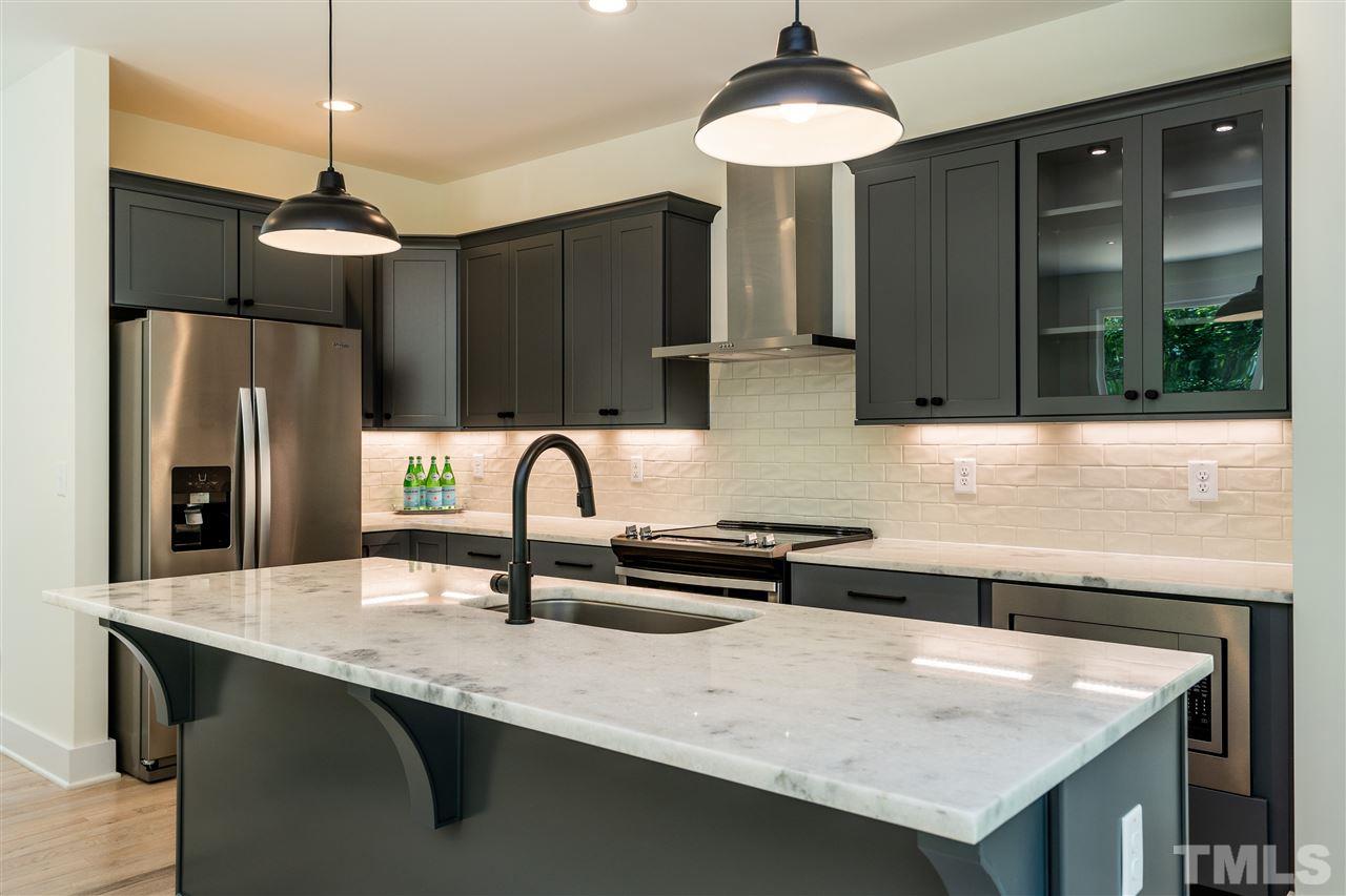 1700 Evergreen Avenue Raleigh, NC 27603 - Photo 14 of 27 a kitchen with stainless steel appliances granite countertop a sink a stove and a refrigerator