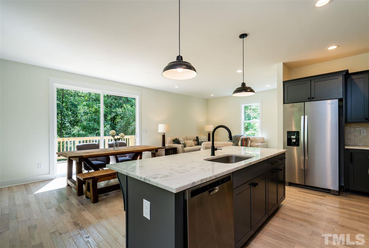 1700 Evergreen Avenue Raleigh, NC 27603 - Photo 16 of 27 a kitchen with kitchen island a counter and a sink
