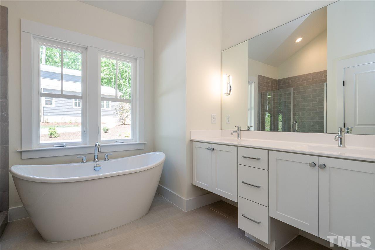1700 Evergreen Avenue Raleigh, NC 27603 - Photo 20 of 27 a spacious bathroom with a tub double sink and mirror
