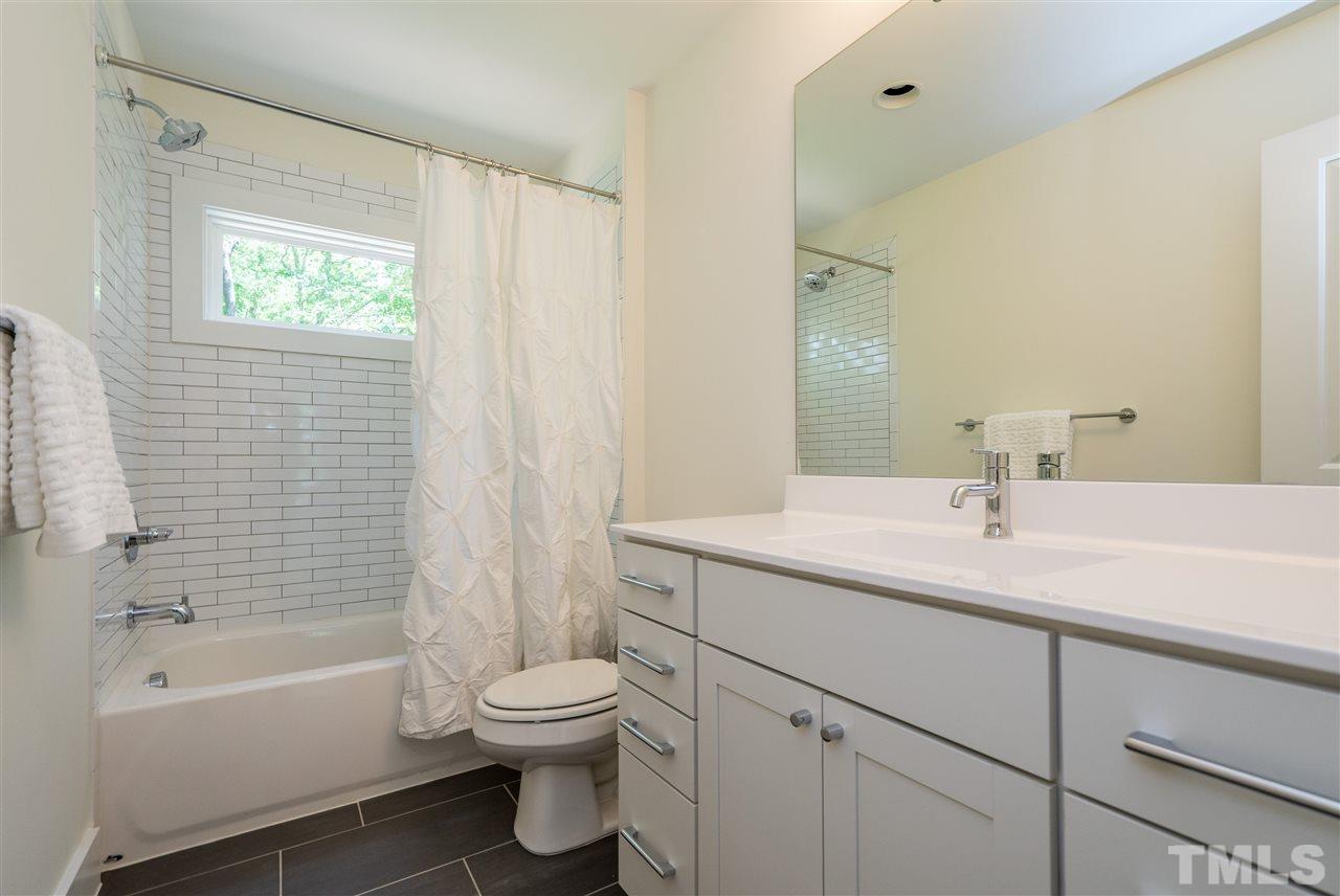 1700 Evergreen Avenue Raleigh, NC 27603 - Photo 24 of 27 a bathroom with a sink toilet a bathtub and shower