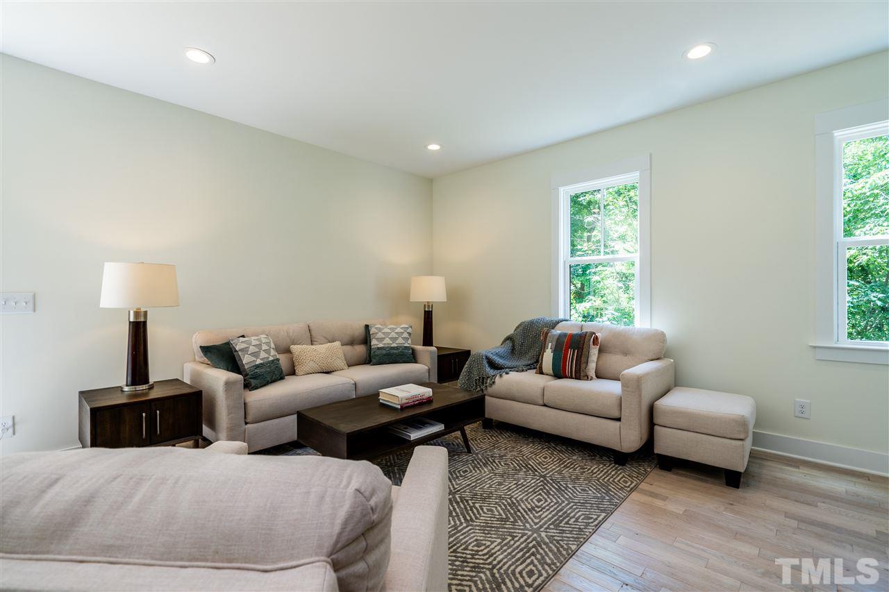 1700 Evergreen Avenue Raleigh, NC 27603 - Photo 8 of 27 a living room with couches and a night stand