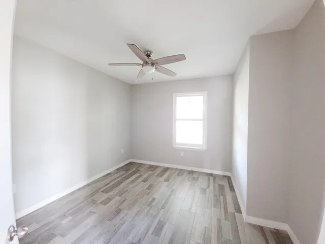 a view of a room with wooden floor
