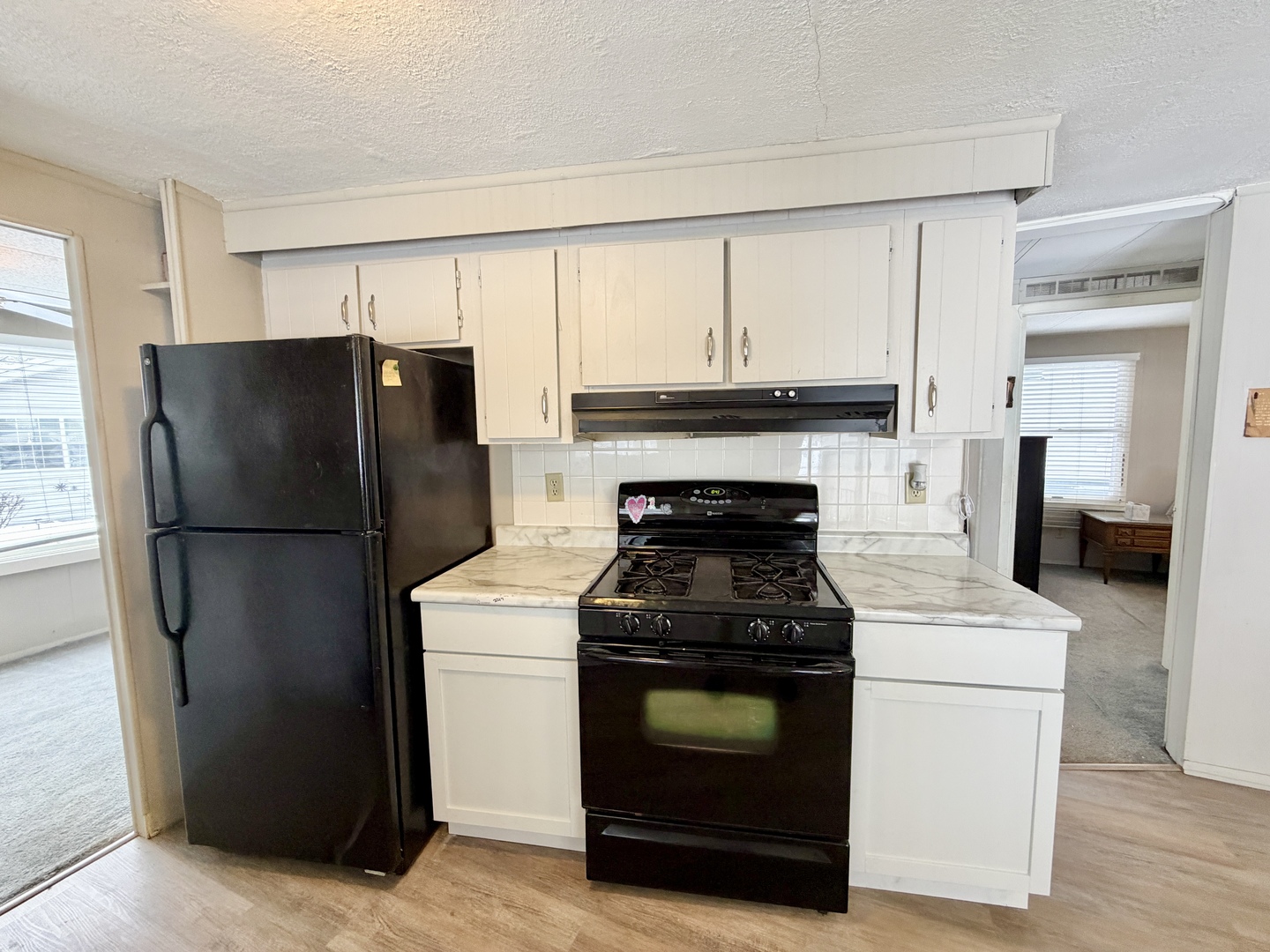 114 Melbrooke Road Elgin, IL 60123 - Photo 11 of 19 a kitchen with a stove and a refrigerator