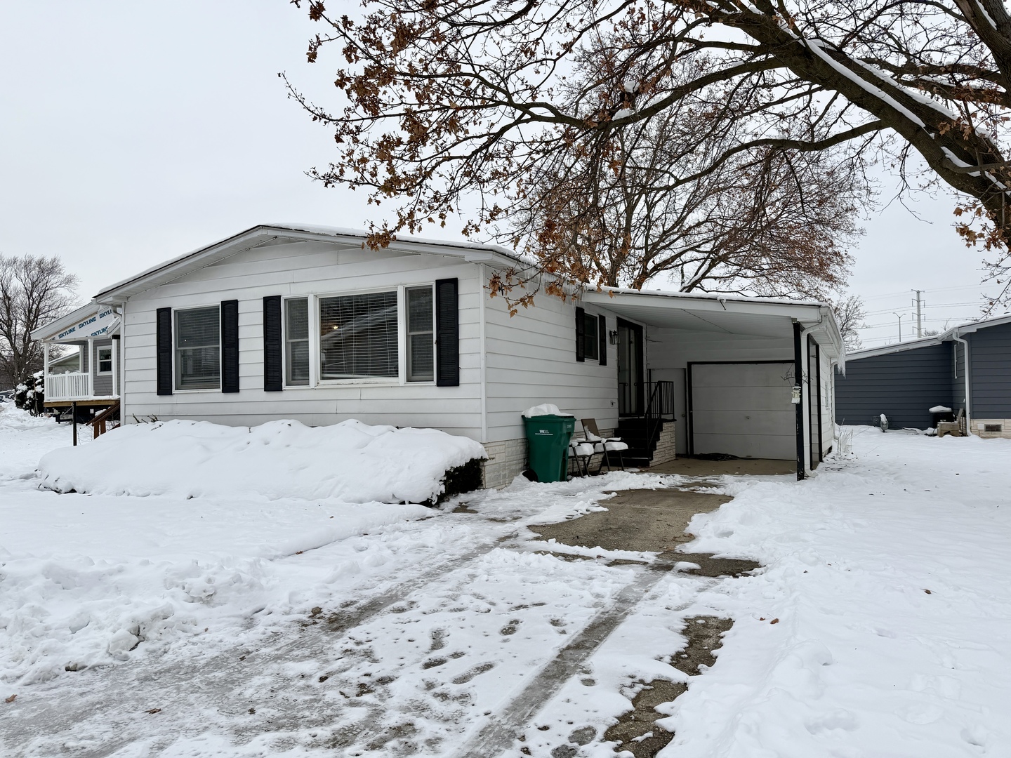 114 Melbrooke Road Elgin, IL 60123 - Photo 2 of 19 a front view of a house with a yard covered in snow