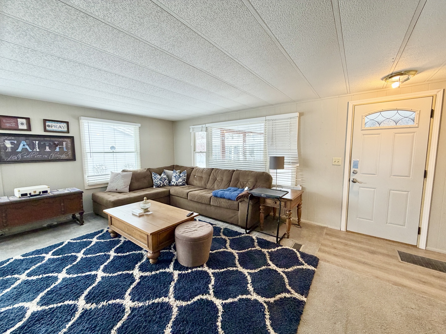 114 Melbrooke Road Elgin, IL 60123 - Photo 4 of 19 a living room with a black white checkered floor with a gaming machine and rug