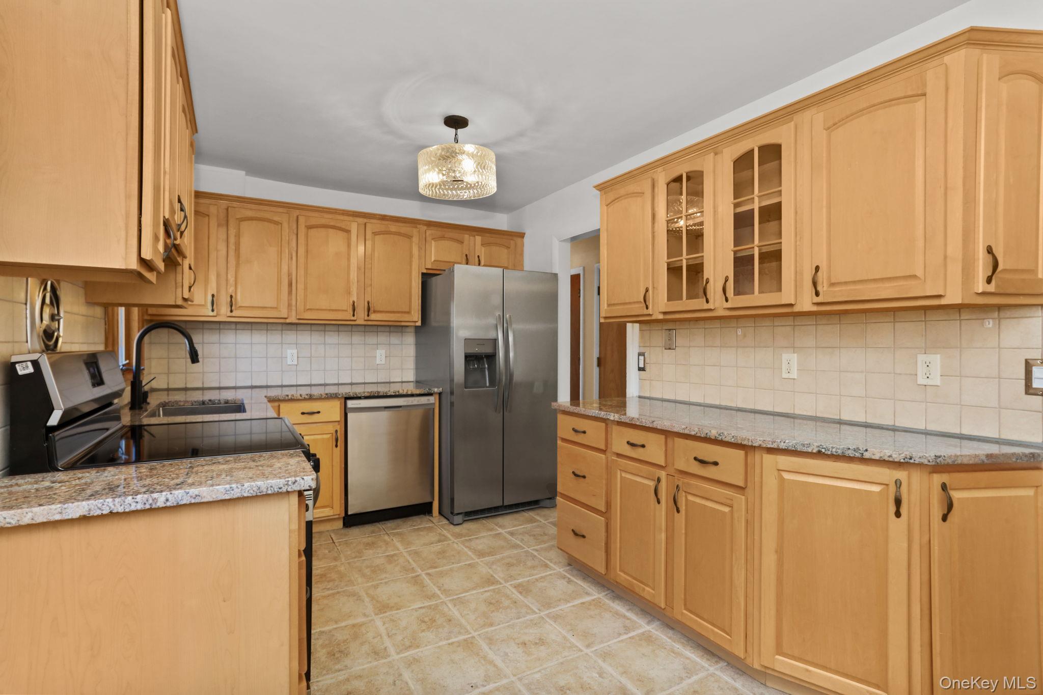 48 Friendly Road Mahopac, NY 10541 - Photo 4 of 24 a kitchen with granite countertop a sink stainless steel appliances and cabinets