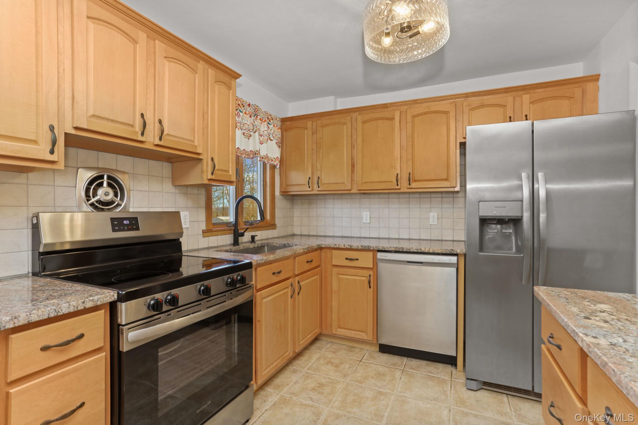48 Friendly Road Mahopac, NY 10541 - Photo 6 of 24 a kitchen with stainless steel appliances granite countertop a sink stove and refrigerator