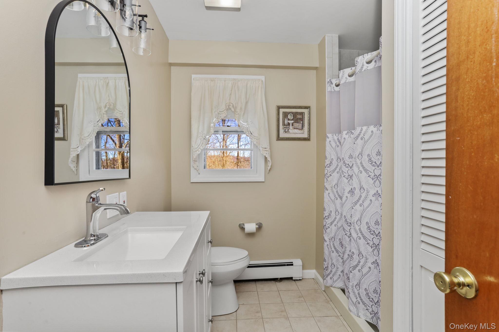 48 Friendly Road Mahopac, NY 10541 - Photo 7 of 24 a bathroom with a toilet sink and mirror