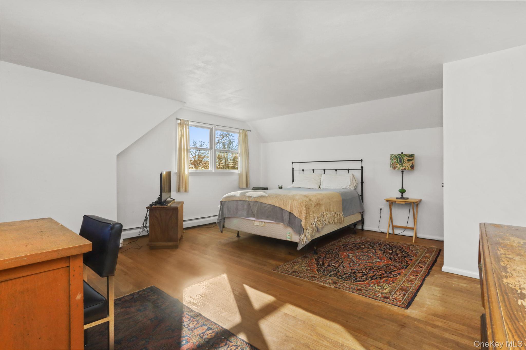 48 Friendly Road Mahopac, NY 10541 - Photo 10 of 24 a bedroom with a bed and wooden floor