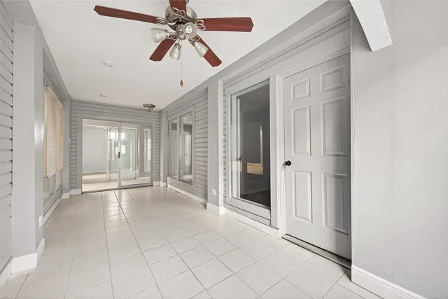 a view of a livingroom with a ceiling fan and window
