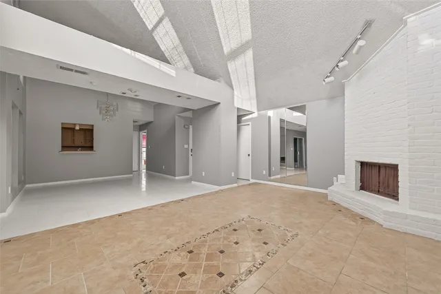 a view of a hallway with wooden floor and a fireplace