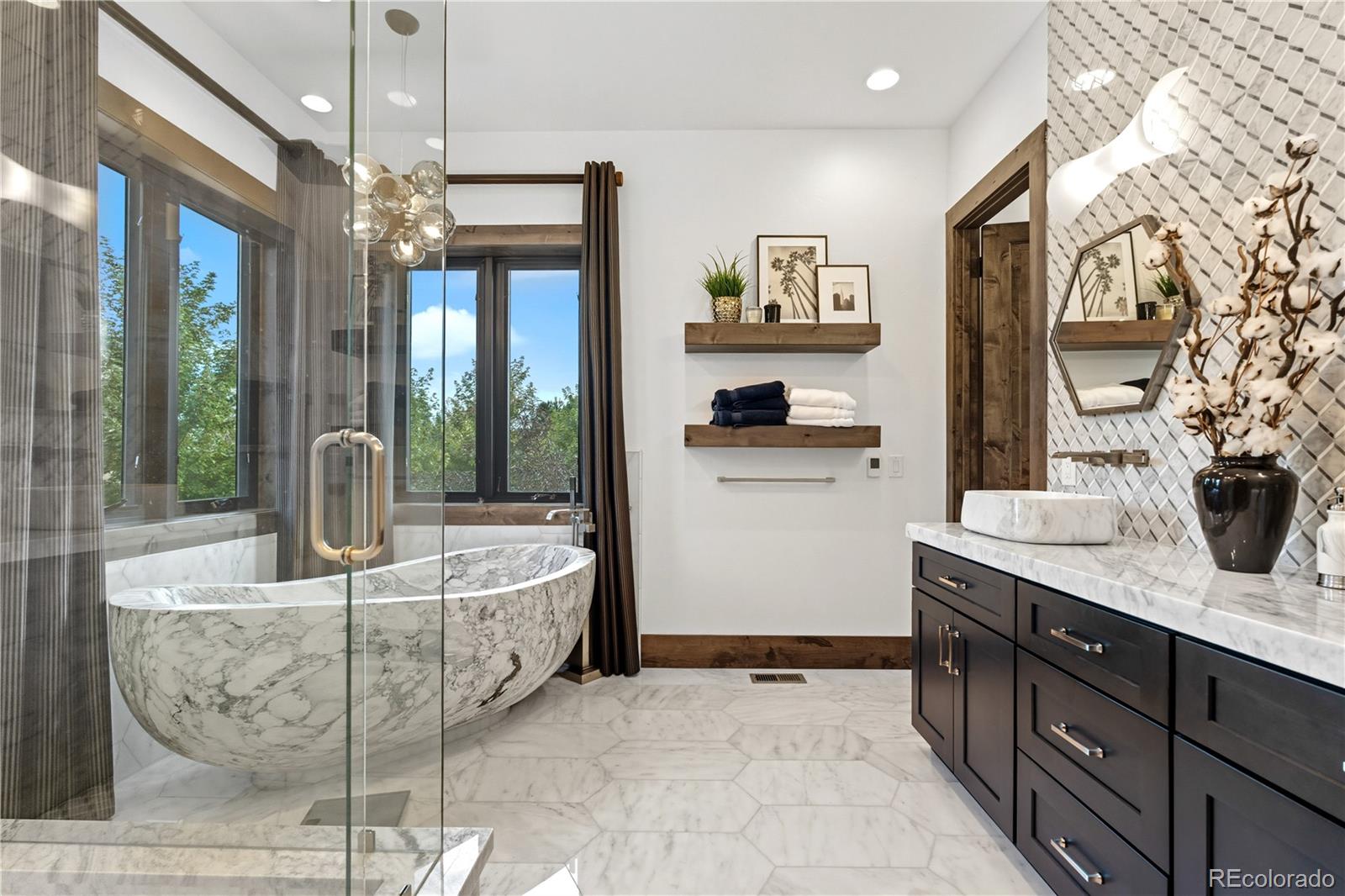1470 White Hawk Ranch Drive Boulder, CO 80303 - Photo 26 of 50 a spacious bathroom with a granite countertop sink a mirror and shower