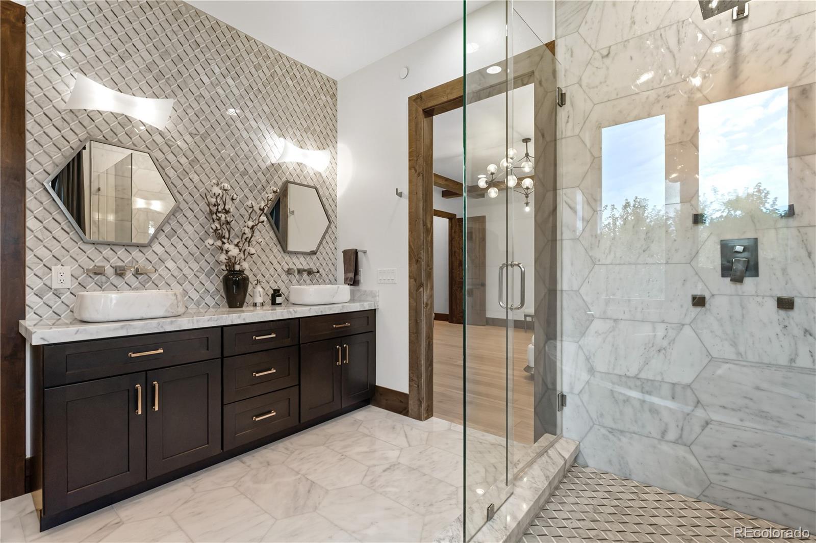 1470 White Hawk Ranch Drive Boulder, CO 80303 - Photo 27 of 50 a bathroom with a double vanity sink mirror and shower