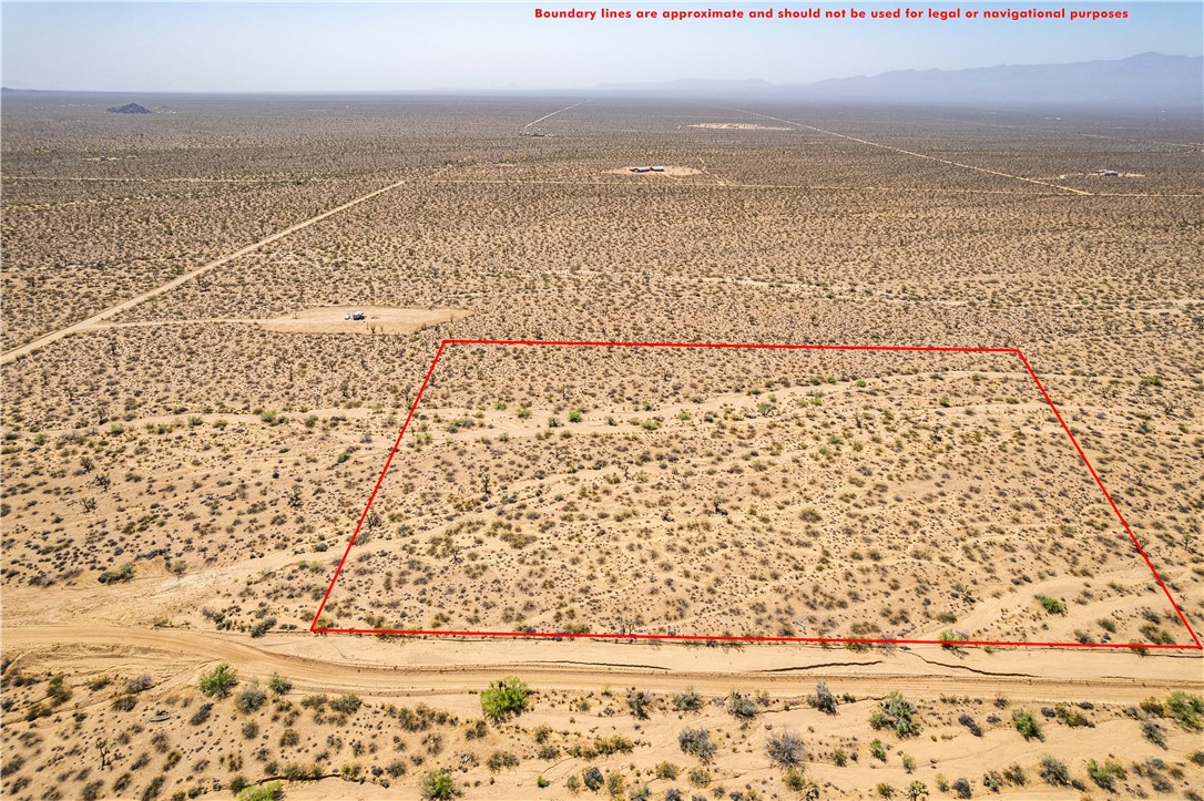 0 East Arroyo Road Yucca, AZ 86438 - Photo 3 of 25 Expansive desert lot featuring a vast, flat terrain with sparse vegetation