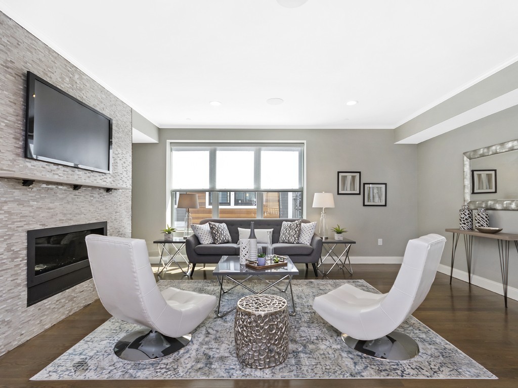 a living room with furniture a flat screen tv and a fireplace
