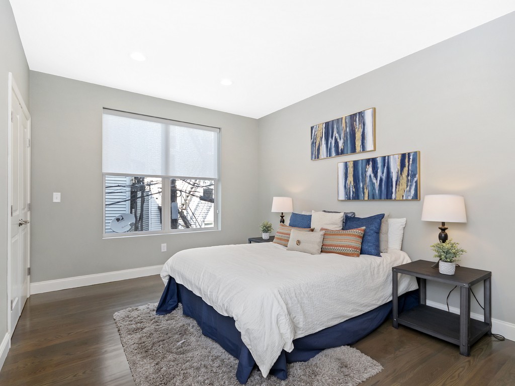 260 Gold Street, Unit 1 Boston, MA 02127 - Photo 11 of 16 a bedroom with a large bed and a window