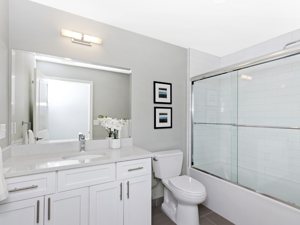 260 Gold Street, Unit 1 Boston, MA 02127 - Photo 12 of 16 a bathroom with a toilet sink and a mirror