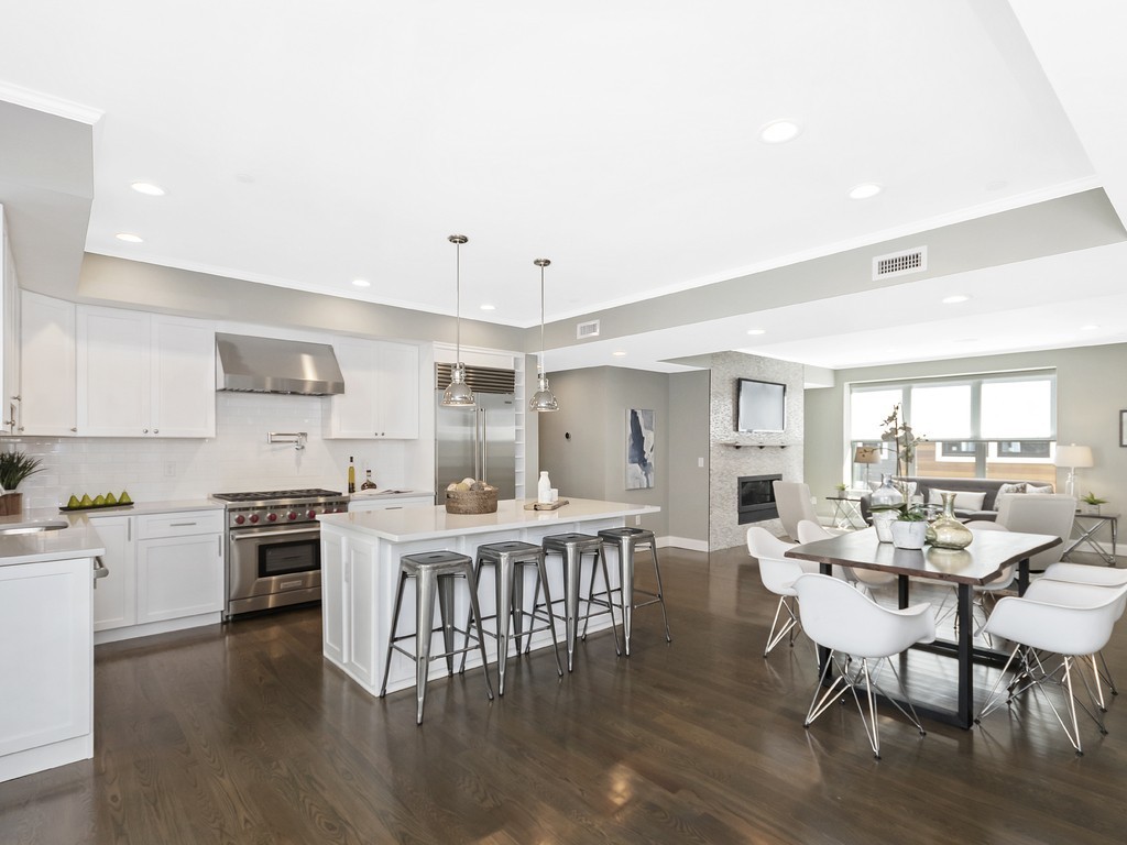 260 Gold Street, Unit 1 Boston, MA 02127 - Photo 2 of 16 a large kitchen with a table and chairs