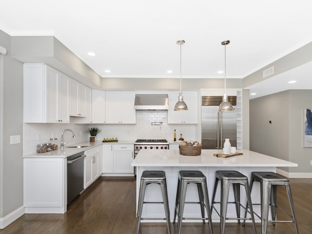 260 Gold Street, Unit 1 Boston, MA 02127 - Photo 3 of 16 a kitchen with granite countertop a dining table chairs and cabinets