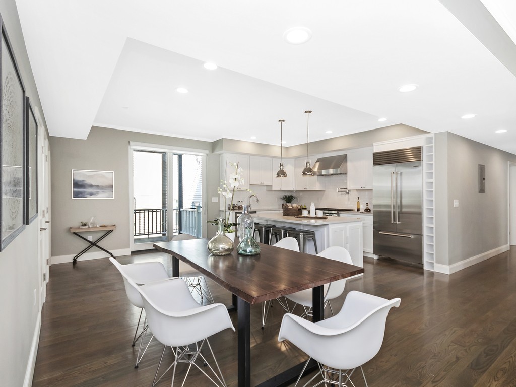 260 Gold Street, Unit 1 Boston, MA 02127 - Photo 5 of 16 a kitchen with stainless steel appliances granite countertop a dining table and chairs